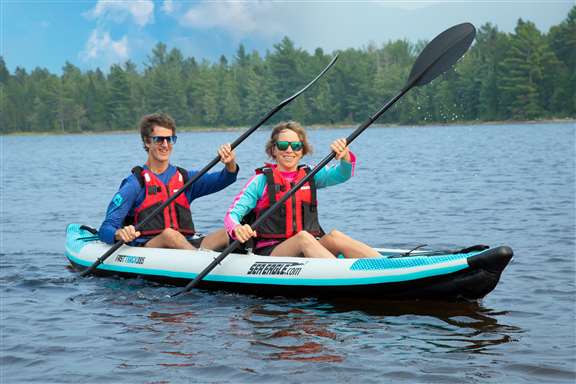 Couple paddling on a lake.